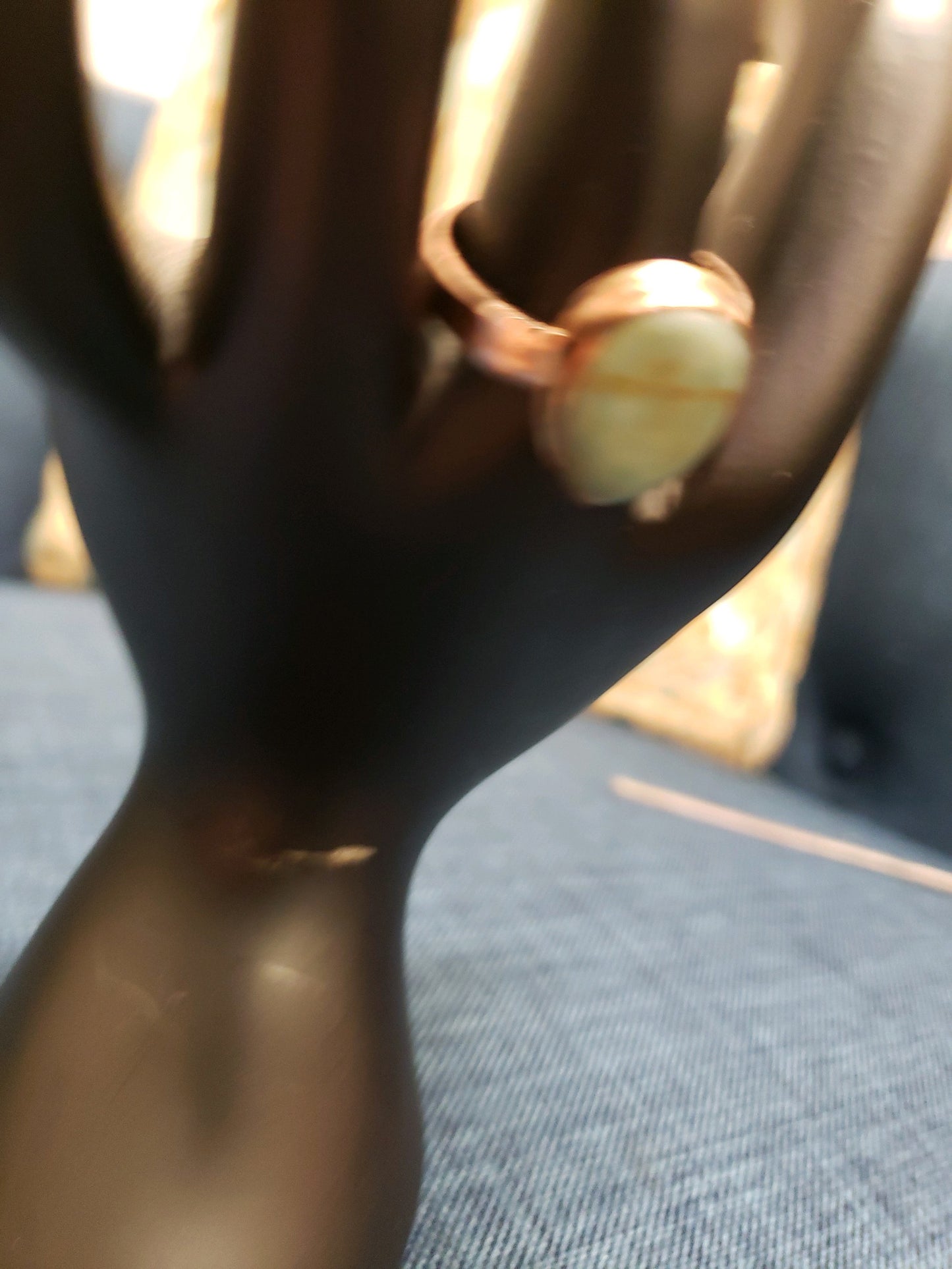 Close-up of a ring on a mannequin hand with a blurred background