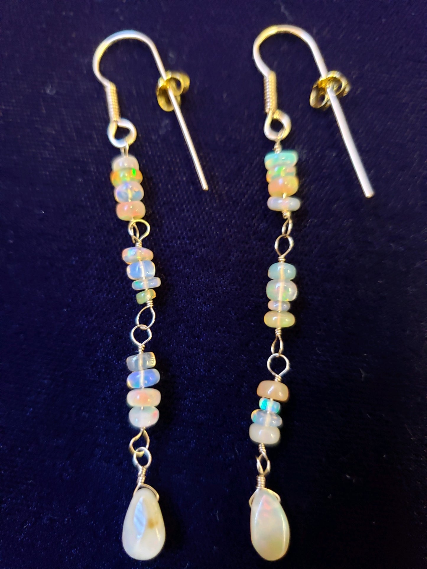 Pair of beaded earrings with a dark blue background
