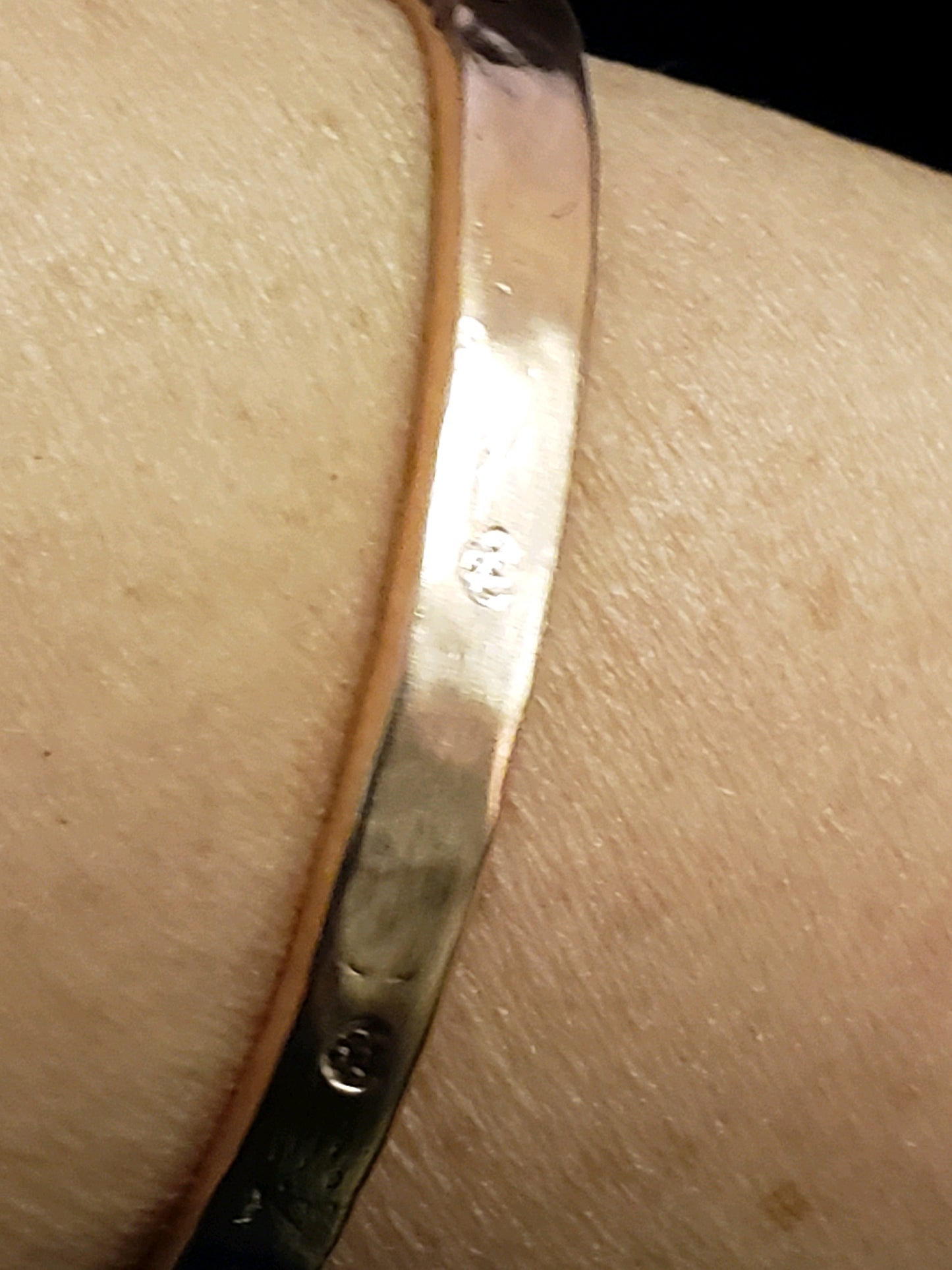 Copper bracelet on a wrist with a close-up view