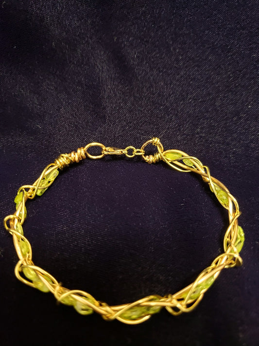  Gold and Peridot bracelet on a black background